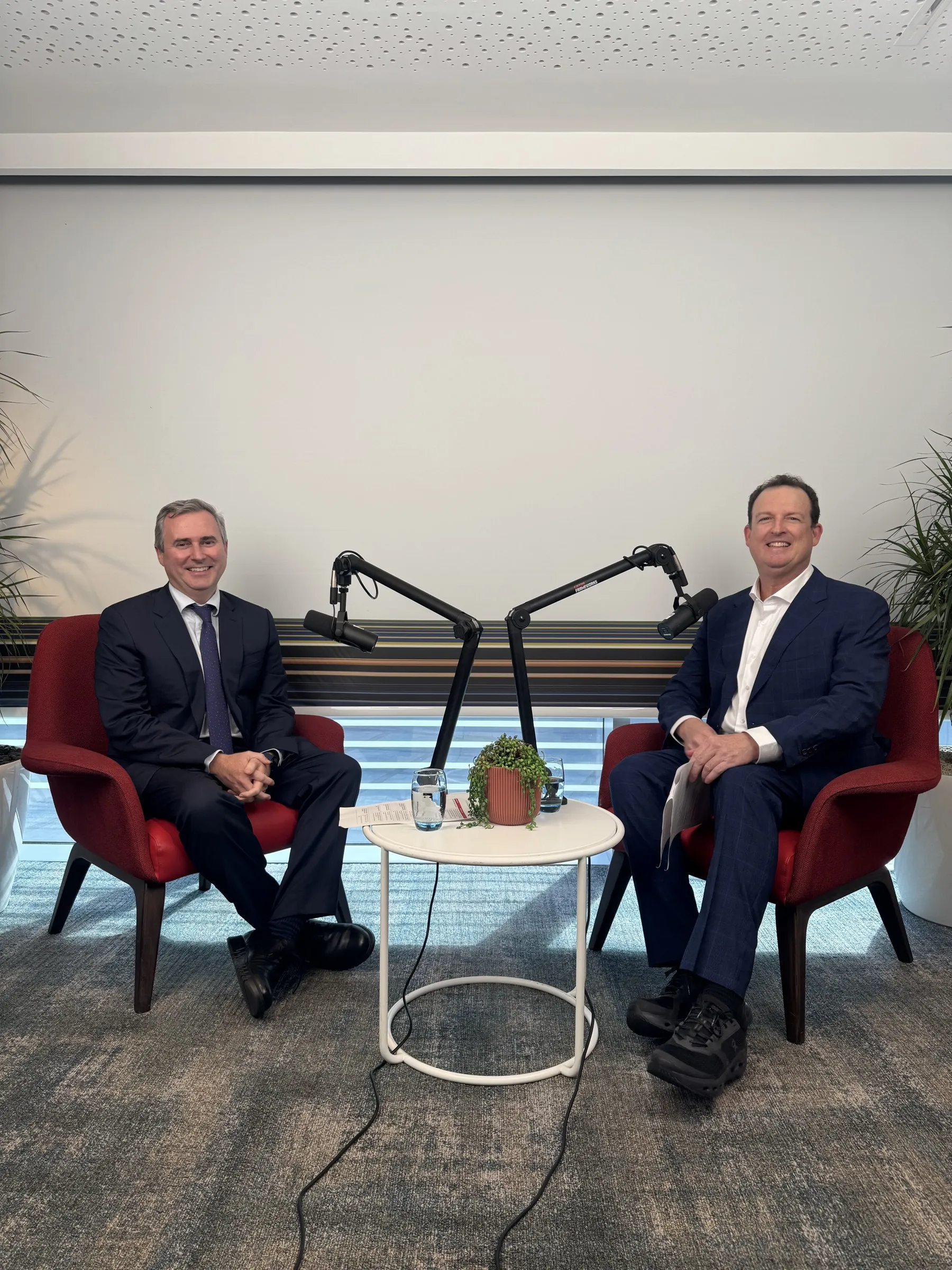 Dr David Gunn and Dr Brendan Cronin seated with boom microphones, recording the Ziemer Femto CAIRS podcast at ExCeL London after the symposium.