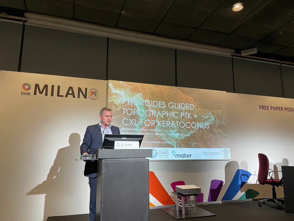 Dr David Gunn presenting Phorcides-guided topographic PTK with cross-linking for keratoconus at the ESCRS Milan 2022 free paper podium.