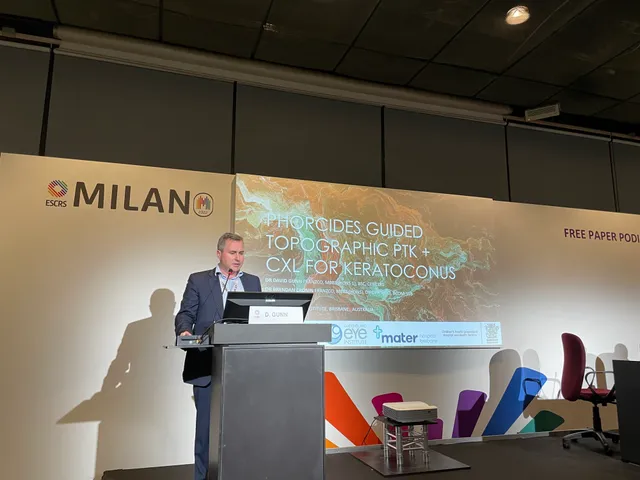 Dr David Gunn presenting Phorcides-guided topographic PTK with cross-linking at the ESCRS Milan 2022 free paper podium.