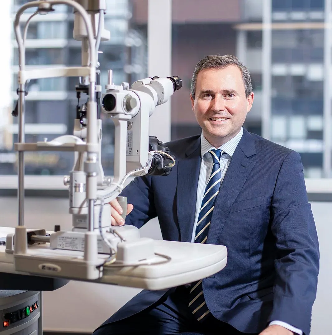 Dr David Gunn sitting at a slit lamp
