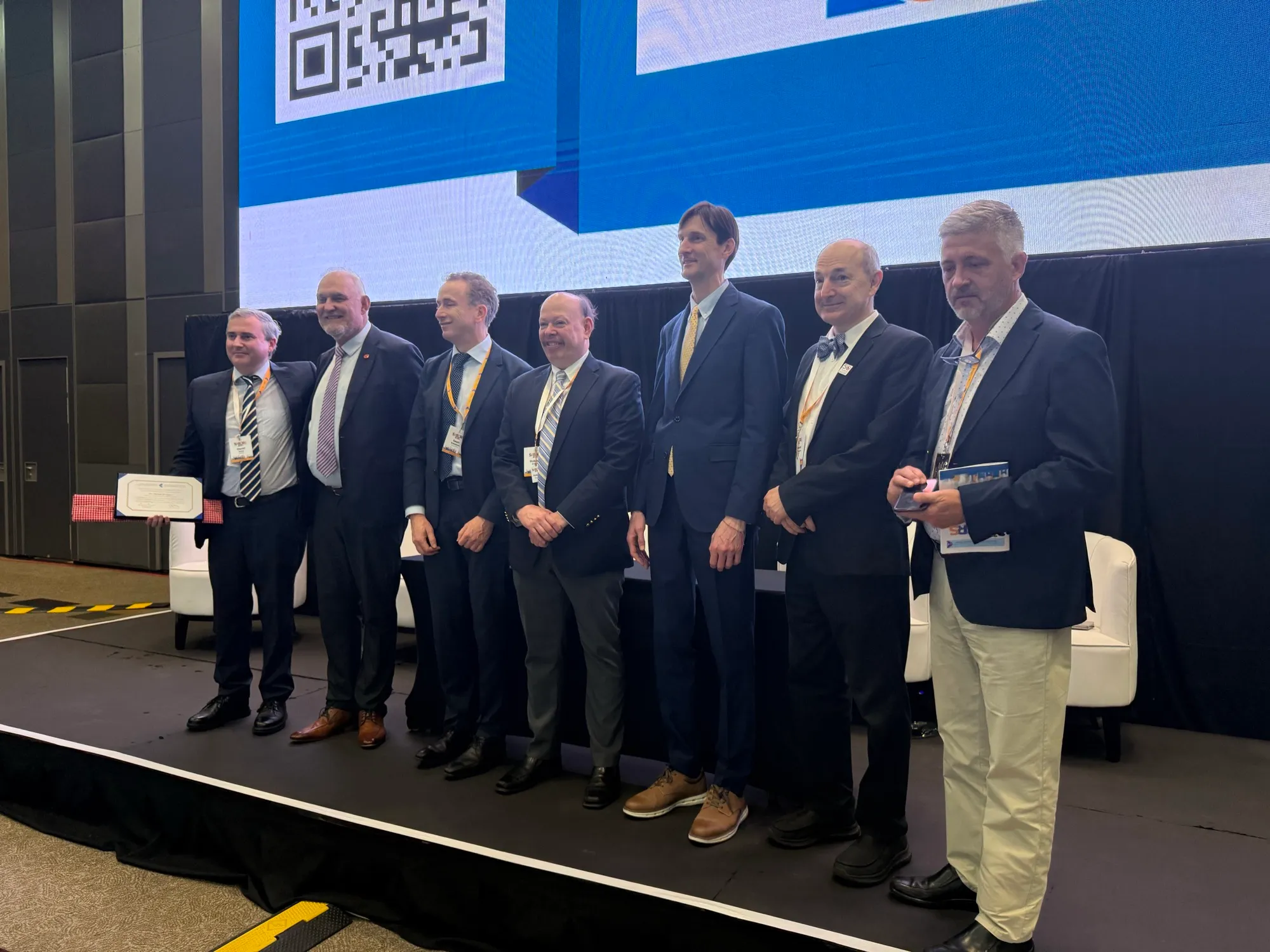 Dr David Gunn, at left holding the 2026 Cornea SA Lecture certificate, on stage with faculty at the 21st SASCRS International Congress in Johannesburg.