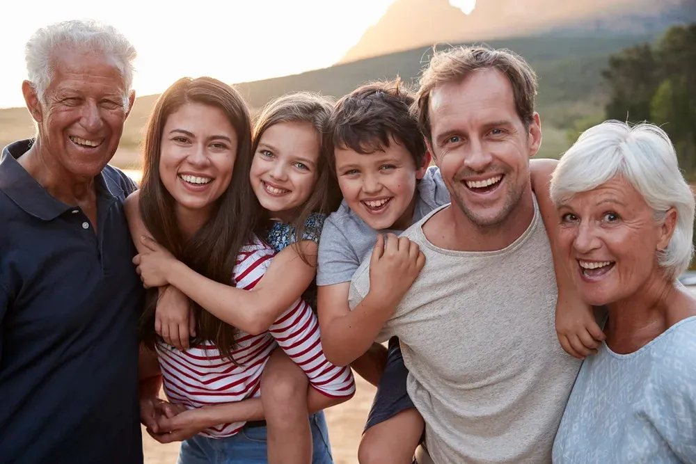 Happy family with three generations at the beach in Brisbane