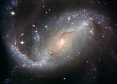 Vibrant spiral galaxy in deep space, featuring bright star clusters and swirling dust, symbolizing Rayner Galaxy IOL innovation.
